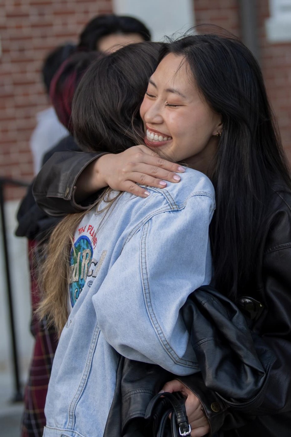 Claudia hugging a friend