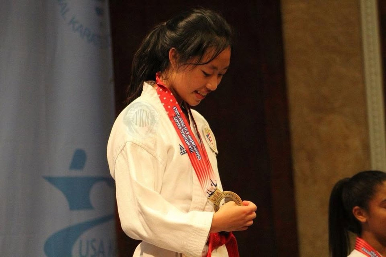 Claudia on the podium with a gold medal at the 2014 US Team Trials