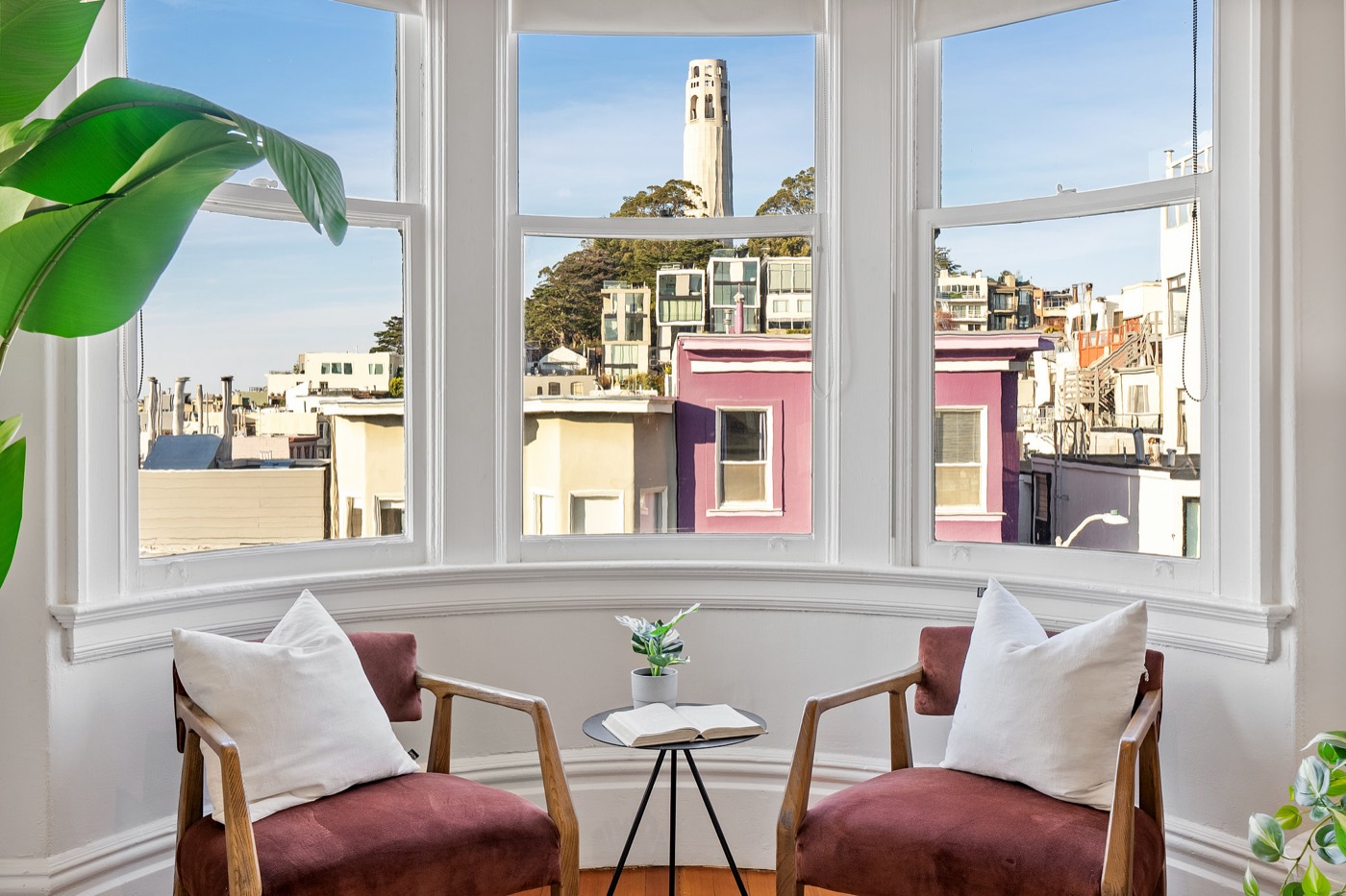 Coit Tower framed by a North Beach bay window